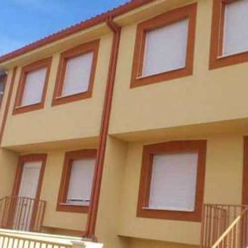 Fachada completa con canalón de chapa en tono rojo